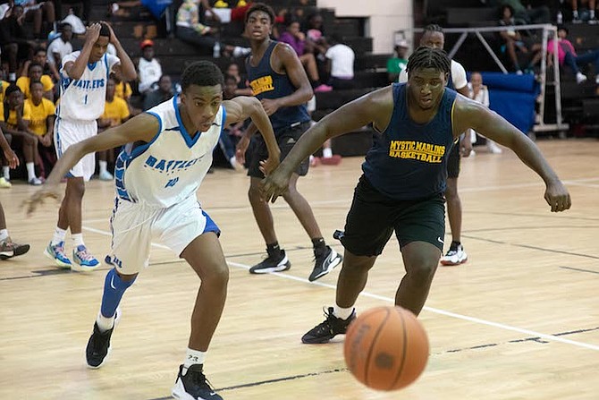 PLAY ACTION: Doris Johnson Mystic Marlins and CI Gibson Rattlers senior boys clash yesterday during the Providence Storm Basketball Club’s Holiday Classic at CI Gibson gym.