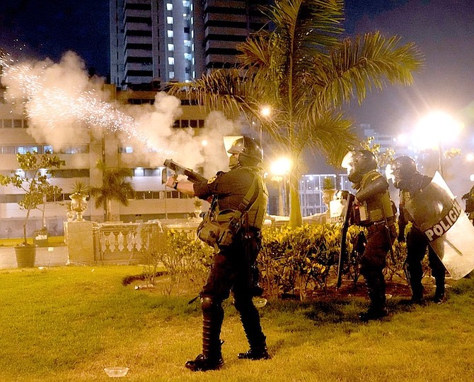 RIOT police fire tear gas at anti-government protesters in Lima, Peru, on Friday.
Photo: Martin Mejia/AP