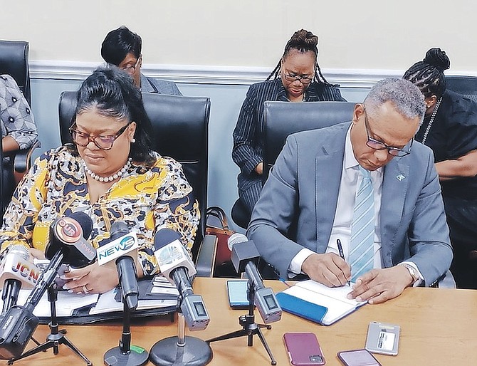 PUBLIC Hospitals Authority managing director Dr Aubynette Rolle alongside Minister of Health and Wellness Dr Michael Darville at yesterday’s signing. Photo: Ulric Woodside/BIS