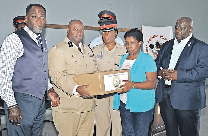 A FOOD donation being presented as part of efforts by members of the Royal Bahamas Police Force. Photo: Vandyke Hepburn