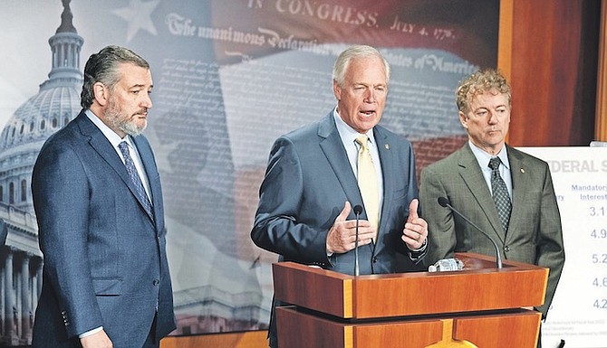 SEN. RON JOHNSON, R-Wisconsin centre, with, Sens Ted Cruz, R-Texas, and Rand Paul, R-Kentucky, talks about debt ceiling during a news conference on Capitol Hill in Washington, yesterday. 
Photo: Manuel Balce Ceneta/AP