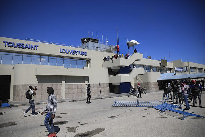 Protesters enter inside the courtyard of the international airport during a demonstration to denounce poor police governance, in Port-au-Prince, Haiti, Thursday. (AP Photo/Odelyn Joseph)