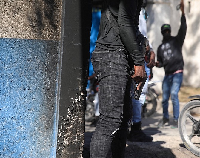 ARMED police officers stand with weapons drawn in front of the police headquarters during a protest to denounce bad police governance, in Port-au-Prince, Haiti, Thursday. 
Photo: Odelyn Joseph/AP