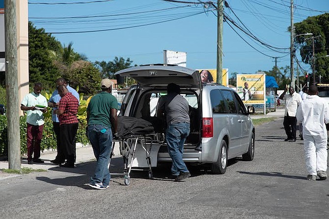 The body of the victim is removed from the scene on Joe Farrington Road on Tuesday. Photo: Moise Amisial