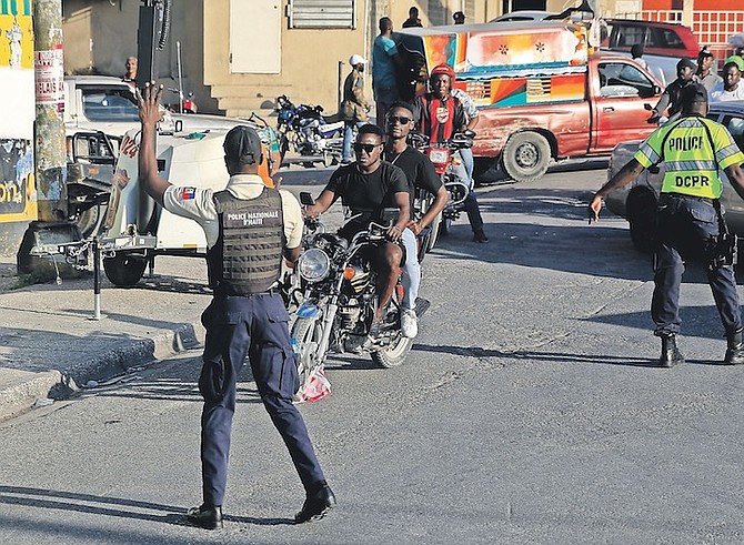 NATIONAL police control security on a street in Port-au-Prince, Haiti, last month.
Photo: Odelyn Joseph/AP