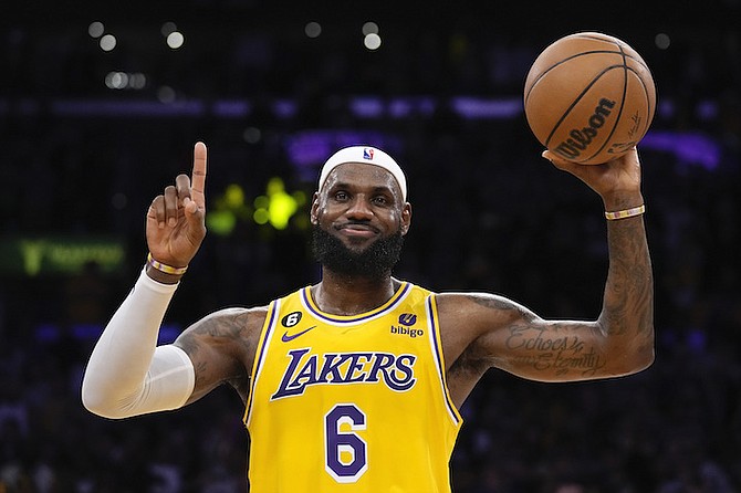 Los Angeles Lakers forward LeBron James gestures after passing Kareem Abdul-Jabbar to become the NBA's all-time leading scorer during the second half of an NBA basketball game against the Oklahoma City Thunder Tuesday, in Los Angeles. (AP Photo/Ashley Landis)
