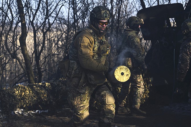 Ukrainian soldiers prepare a cannon to fire in the frontline close to Bakhmut, Donetsk region, Ukraine, Wednesday. (AP Photo/Libkos)