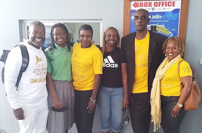 GET YOURS TODAY: Bahamians share a special moment with Local Organising Committee members as they purchase their CARIFTA tickets yesterday at the Thomas A Robinson National Stadium.