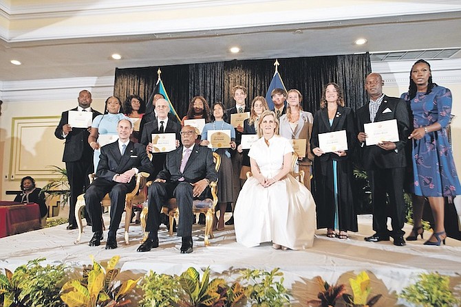 GOVERNOR General CA Smith flanked by Royal visitors Prince Edward and Sophie, Countess of Wessex and Forfar, last night along with Governor General’s Youth Awards recipients. 
Photos: Moise Amisial/Tribune Staff