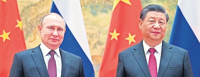 CHINESE President Xi Jinping, right, and Russian President Vladimir Putin pose for a photo prior to their talks in Beijing, China, February 4, 2022. One year into Russia’s war against Ukraine, China is offering a 12-point proposal to end the fighting. 
Photo: Alexei Druzhinin/AP