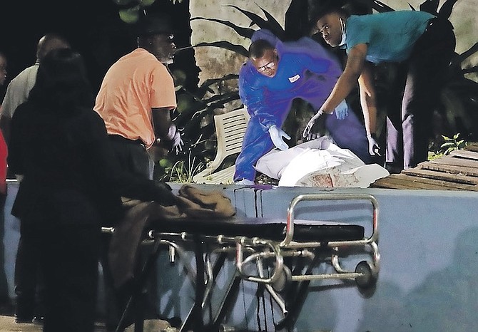 A body is removed from the scene last night in Fox Hill Park after a shooting left two men dead. 
Photo: Austin Fernander