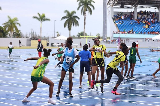 ON TRACK: High school students compete yesterday on day one of the Government Secondary Schools Sports Association (GSSSA) Track and Field Championships. The C.H. Reeves Raptors and C.R. Walker Knights are leading their respective divisions. 
Photos: Austin Fernander/Tribune Staff