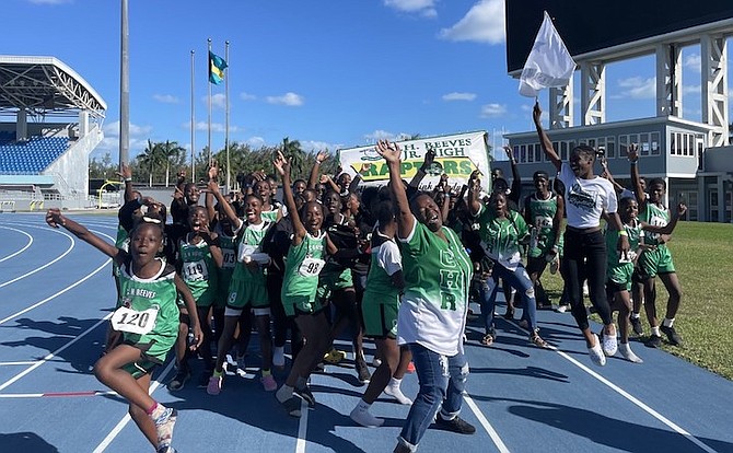 WINNING WAYS: The C.H. Reeves Raptors celebrate yesterday after winning the Government Secondary Schools Sports Association (GSSSA) junior track and field championships. 
Photo: Tenajh Sweeting