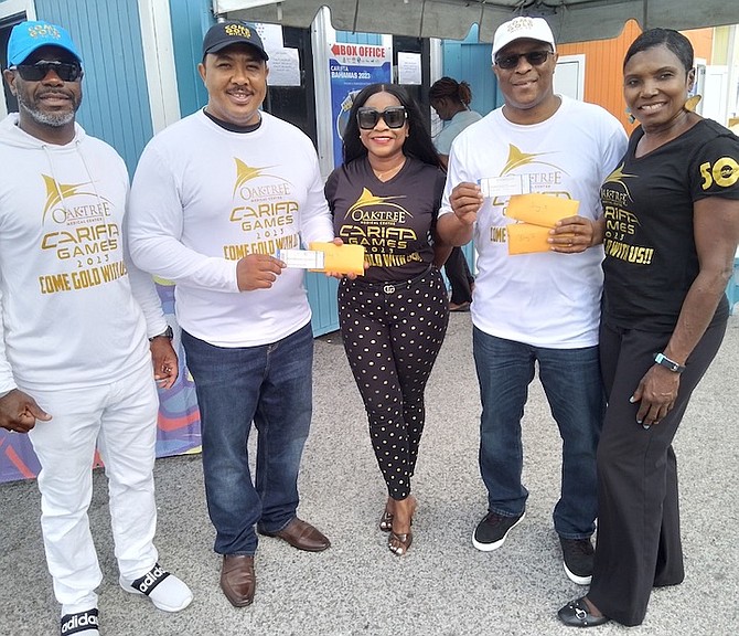 FNM leader Michael Pintard and Deputy leader Shanendon Cartwright are flanked by LOC CEO Lynden Maycock, Marketing manager Fern Hanna and Dame of Carifta Pauline Davis as they purchase tickets for the Carifta Games.