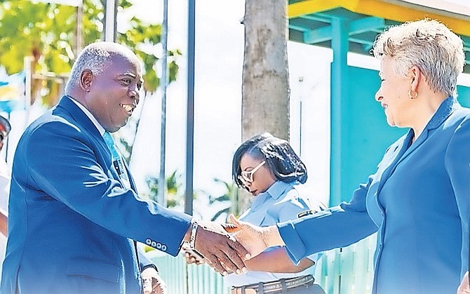 PRIME Minister Philip “Brave” Davis shaking hands with Education Minister Glenys Hanna Martin on Friday during a visit to SC McPherson school. Photos: OPM