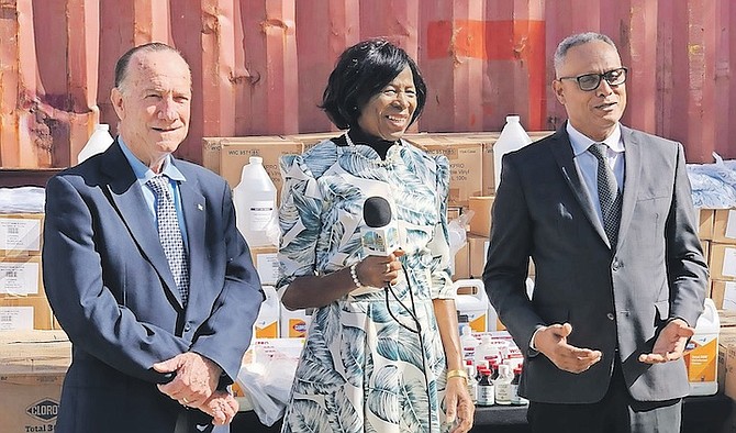 CYNTHIA ‘Mother’ Pratt’s foundation made a donation to the Ministry of Health and Wellness of cleaning supplies and other utensils. Pictured above (l-r) are Permanent Secretary of the Ministry of Health and Wellness Colin Higgs, ‘Mother’ Pratt, and Minister of Health and Wellness Dr Michael Darville. 
Photos: Kathryn Campbell/BIS