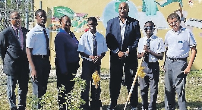 MINISTER of Environment and Natural Resources Vaughn Miller along with senior forestry officer Danielle Hanek took part in a tree planting ceremony at Jack Hayward Junior High School yesterday. They planted a Yellow Elder and a Lignum Vitae.