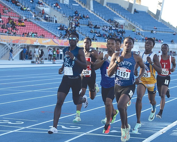 KEEPING THE PACE: Athletes compete in the Bahamas Association of Athletic Associations’ National High School Track and Field Championships and final CARIFTA Trials at the Thomas A. Robinson National Stadium yesterday. 
Photo: Austin Fernander/Tribune Staff