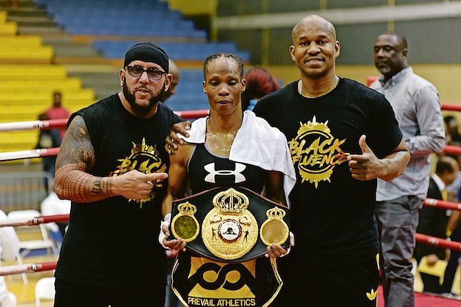 Jaimie “The Miracle” Mitchell with her belt and corner trainers after beating Toronto’s Lindsay Garbatt in the 10-round main event.
                                                                                                                                                                                                Photos by Moises Amisial/Tribune Staff