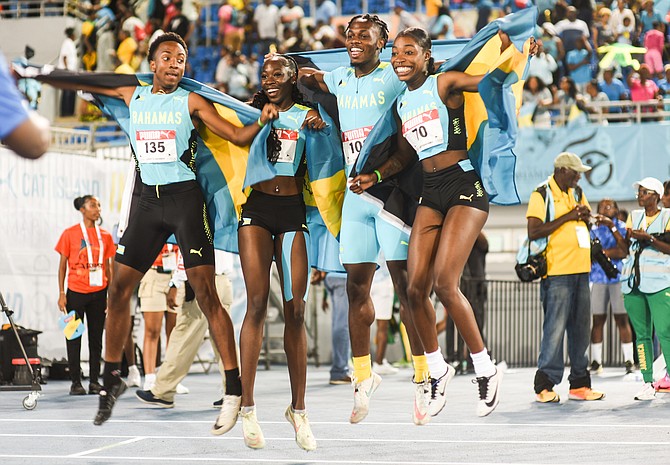 The Bahamas' mixed 4 x 400m team of Tumani Skinner, Lacarthea Cooper, Shimar Bain and Javónya Valcourt celebrate their CARIFTA Games gold medal victory on Sunday night at the Thomas A Robinson National Stadium. Three days of thrilling competition came to a close last night. 
Photo: Moise Amisial