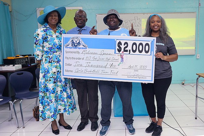 Former Deputy Prime Minister Cynthia “Mother” Pratt, HO Nash principal Andre Nairn and Melissa Spann join in the cheque presentation to coach Patricia “Pattie” Johnson.