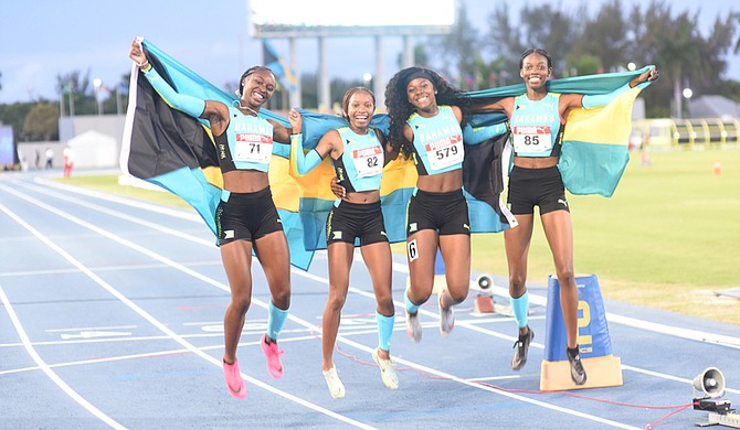 GOLDEN MOMENT: From left to right are under-17 girls 4x100 metre relay gold winners Darvinique Dean, Bayli Major, Shayann Demeritte and Jamiah Nabbie.
Photo: Moises Amisial/Tribune Staff