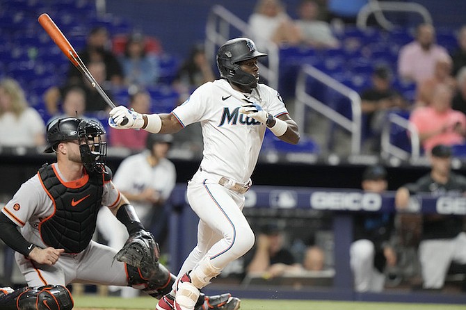 Miami Marlins' Jazz Chisholm Jr., right, grounds into a force out with Jorge Soler out at second during the eighth inning of a baseball game, Tuesday, April 18, 2023, in Miami. Chisholm Jr. advanced to first on the play. San Francisco Giants catcher Blake Sabol, left, looks on. (AP Photo/Lynne Sladky)