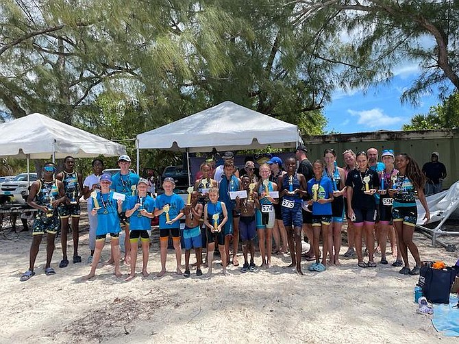 YOUNG TRIATHLETES with their medals and trophies after the Bahamas Triathlon Association hosted the Sea Waves Triathlon yesterday at Jaws Beach. 
Photo: Tenajh Sweeting