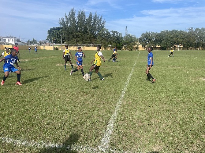 SOCCER IS BACK: Anatol Rodgers Timberwolves in battle against the LW Young Golden Eagles’ junior girls on CH Reeves playing field.
Photo: Tenajh Sweeting