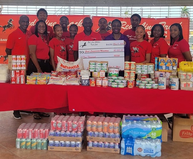 LENDING A HAND: Red-Line Athletics track club donated a $2,000 cheque and dry goods to the Great Commission Ministries in efforts to give back.