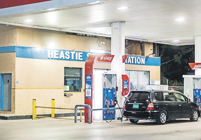 A DRIVER filling up at a New Providence gas station last night. Photo: Moise Amisial