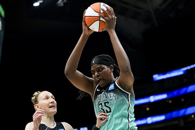 New York Liberty forward Jonquel Jones (35) gets the rebound against the Seattle Storm as guard Courtney Vandersloot looks on during the first half on May 30 in Seattle. 
(AP Photo/Lindsey Wasson)