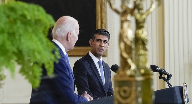 British Prime Minister Rishi Sunak listens as President Joe Biden speaks during a news conference, as seen in a reflection, in the East Room of the White House in Washington, Thursday, June 8, 2023. 			    Photo: Susan Walsh/AP