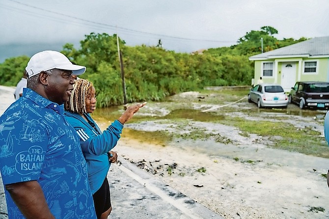 Prime Minister Philip ‘Brave Davis’ speaks with a resident of Exuma yesterday as he and a delegation view the impact of recent flooding on the island.
Photo: OPM Communications
