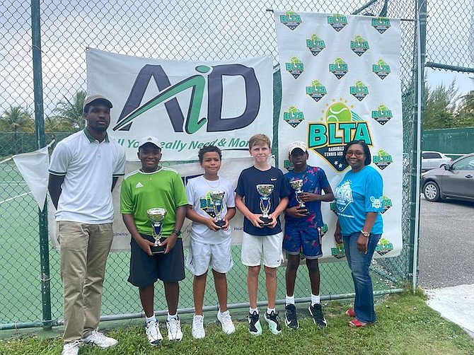 WE ARE THE CHAMPIONS: Chase Newbold (under 12 boys singles champion) with the runner up Khai Rees and Patrick Mactaggart (under 14 boys singles champion) alongside runner up Ayai Bethel yesterday at the National Tennis Centre.