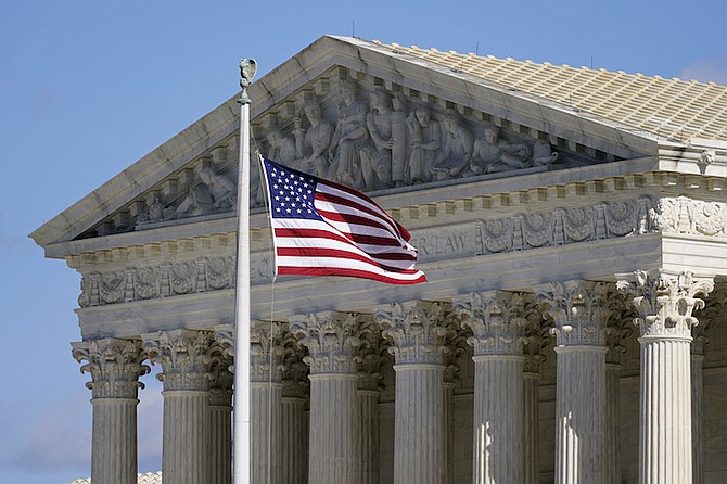 An American flag waves in front of the Supreme Court building on Capitol Hill in Washington.
(AP Photo/Patrick Semansky, File)