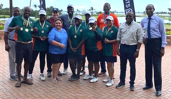 Andros Chickcharnies members get their gold medals from Deputy Prime Minister Chester Cooper, Craig Flowers and David Slatter.