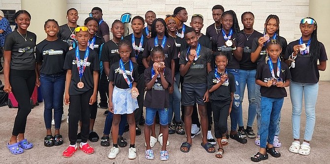 BRINGING HOME THE MEDALS: The Roadrunners Track & Field Club show off their medals won at the annual AAU Club Championship in Orlando, Florida.