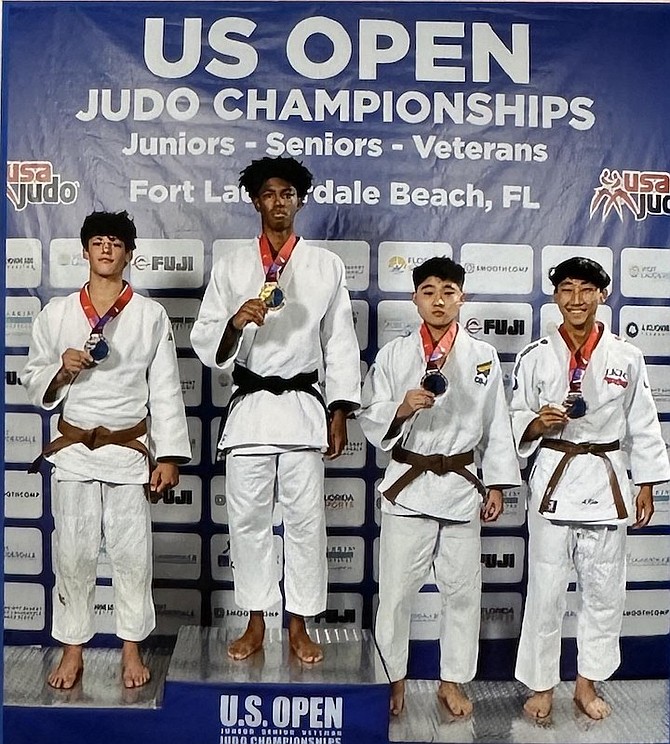 Xavion Johnson, of The Bahamas, on top of podium with other medallists at the US Open Championships at the Fort Lauderdale Convention Center in Fort Lauderdale, Florida, on Saturday.
