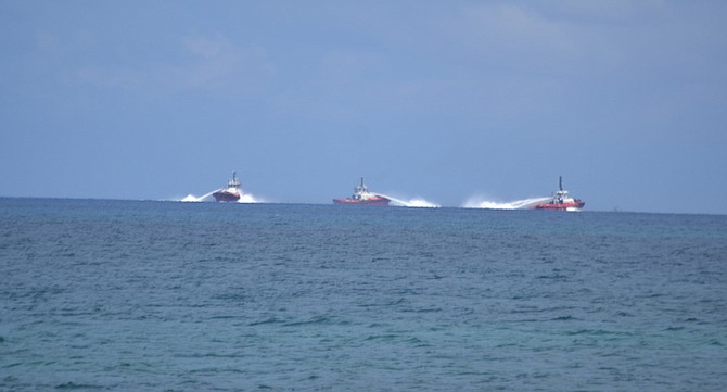 BUCKEYE boats spotted working to clean the oil spill from Berth 8 at their Grand Bahama facility recently.
Photo: Waterkeepers Bahamas