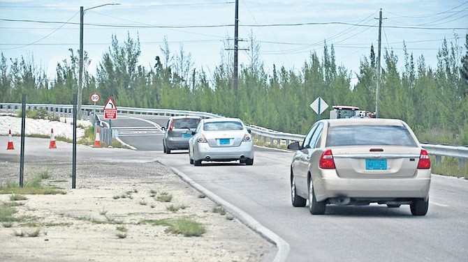 CARS using Fishing Hole Road yesterday after the bridge reopened. Photo: Vandyke Hepburn