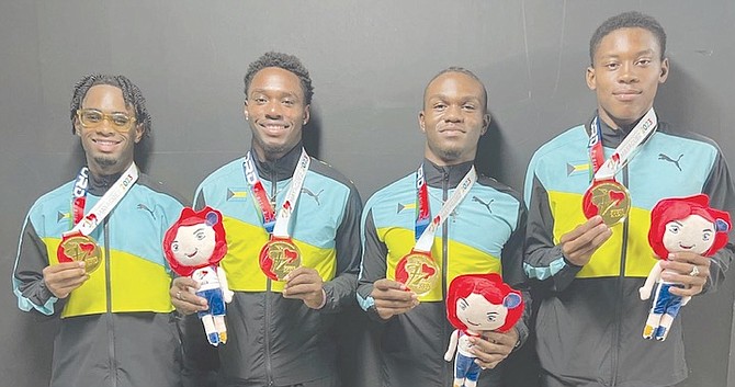 Bahamas men’s team, from left to right, of Adam Musgrove, Carlos Brown, Jeremiah Adderley and Zion Campbell proudly hold up their gold medals. 
Photo: Daron Lightbourne