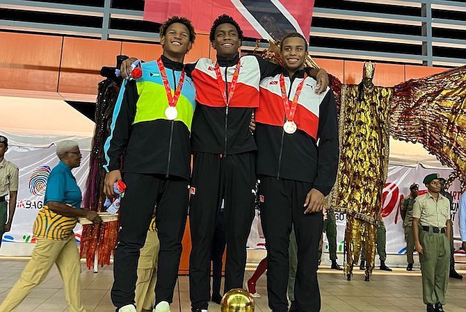 ON THE MEDAL PODIUM: Shown, from left to right, are Bahamas’ Marvin Johnson Jr, men’s 50m freestyle silver medallist, alongside the host country’s gold medallist Nikoli Blackman and bronze medallist Zarek Wilson, of Trinidad and Tobago.
Photo courtesy of Keianna Moss
