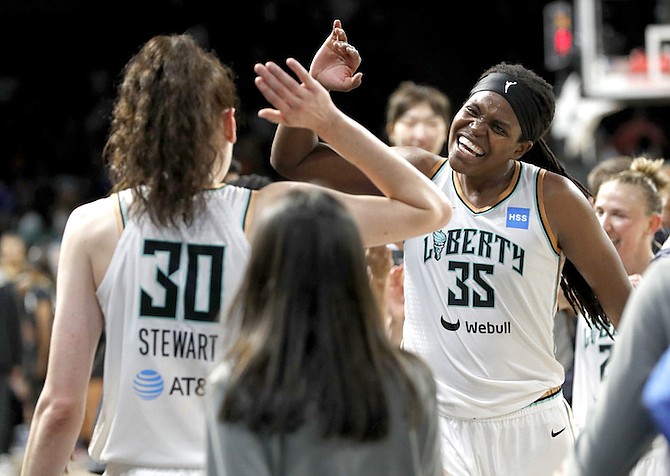 New York Liberty forward Breanna Stewart (30) celebrates with forward Jonquel Jones (35) near the end of the team’s win over the Las Vegas Aces in a basketball game for the WNBA Commissioner’s Cup championship last night in Las Vegas. 
(Steve Marcus/Las Vegas Sun via AP)