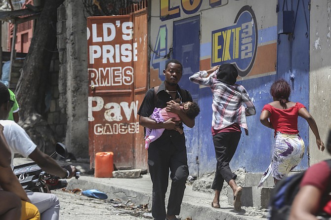 RESIDENTS flee their homes to escape clashes between armed gangs in the Carrefour-Feuilles
district of Port-au-Prince, Haiti, Tuesday.
Photo: Odelyn Joseph/AP