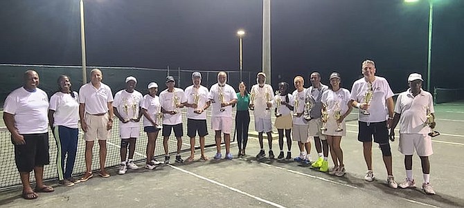 CHAMPIONS UNITE: Winners of the 29th AID Clay Court Tennis Championships hoist their championship hardware following two weeks of competition at the Gym Tennis Club in Winton Meadows.