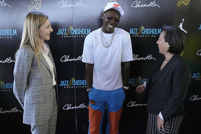 Jazz Chisholm Jr, centre, chats with Miami Marlins general manager Kim Ng, right, and Marlins president of business operations Caroline O’Connor, left.