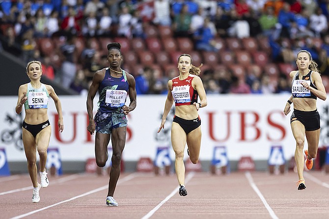 Shaunae Miller-Uibo, of The Bahamas, centre, crosses the finish line to win the women’s 400 metres final race during the World Athletics Diamond League meeting at the Letzigrund stadium in Zurich, Switzerland, yesterday. 
(Michael Buholzer/Keystone via AP)