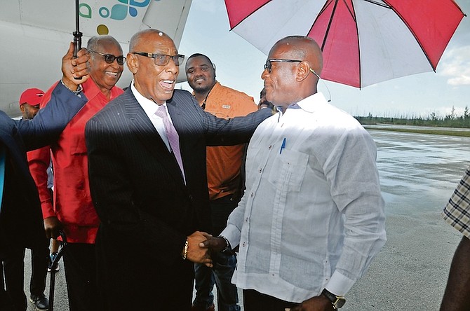 FREE National Movement leader Michael Pintard and a contingent of supporters greet former Governor General Cornelius A Smith at the airport in Grand Bahama as he arrives home.
Photos: Vandyke Hepburn