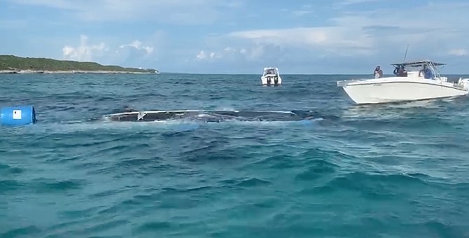 A still from video showing the capsized boat off Rose Island.